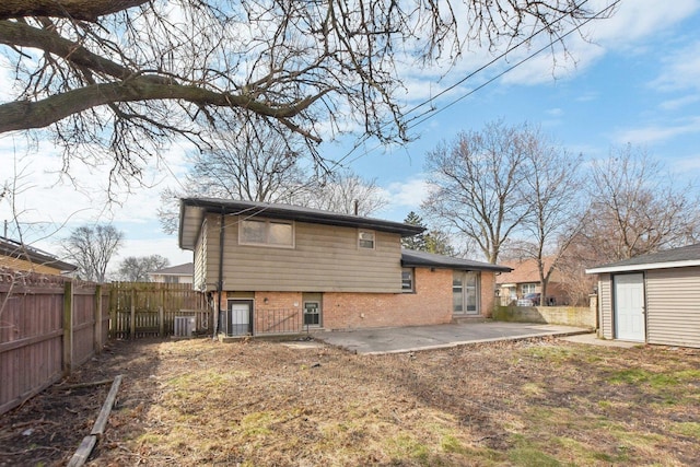 1848 172nd St, East Hazel Crest, IL 60429 - rear view of property featuring a patio area, brick siding, central AC, and an outbuilding