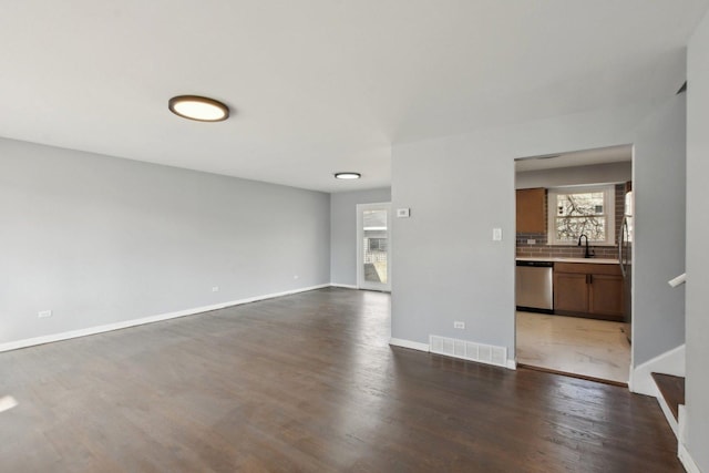 1848 172nd St, East Hazel Crest, IL 60429 - unfurnished living room featuring dark wood-style flooring, a sink, baseboards, and stairway