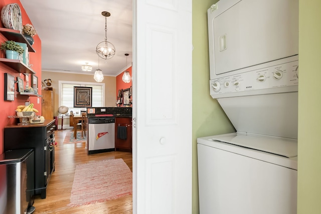 206 S Lombard Ave Unit 206B, Oak Park, IL 60302 - laundry room featuring stacked washer and clothes dryer, ornamental molding, and light wood-style floors