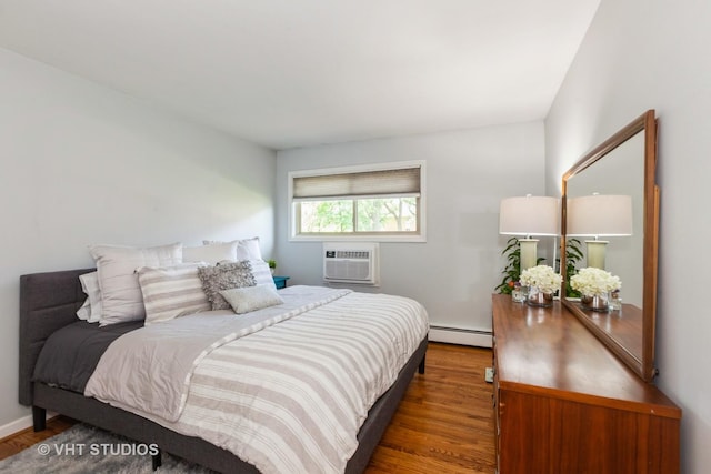 5730 Concord Ln Unit 7, Clarendon Hills, IL 60514 - bedroom featuring a baseboard heating unit, a wall mounted air conditioner, and wood finished floors