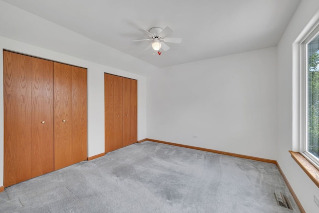 26437 W Deer Path, Channahon, IL 60410 - unfurnished bedroom with multiple closets, carpet floors, baseboards, and ceiling fan