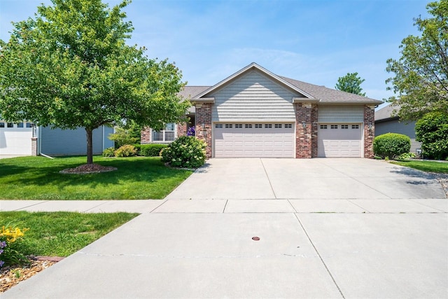 1720 Eide Rd, Bloomington, IL 61704 - view of front of property with an attached garage, a front yard, and driveway
