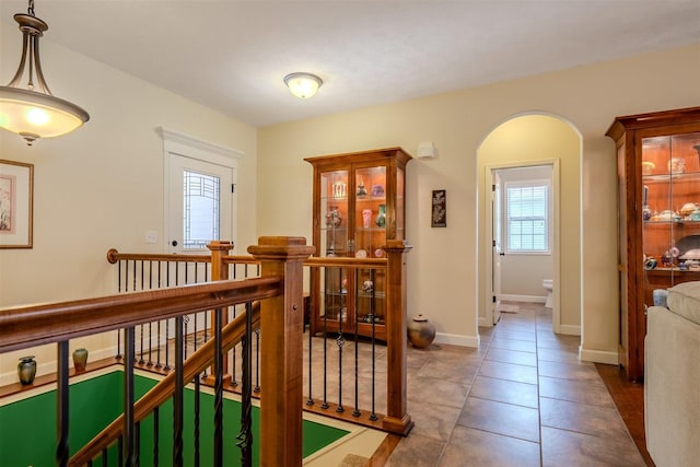 1720 Eide Rd, Bloomington, IL 61704 - hallway featuring an upstairs landing, tile patterned flooring, and arched walkways