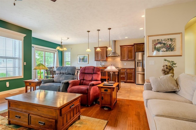 1720 Eide Rd, Bloomington, IL 61704 - living area featuring dark wood finished floors, a chandelier, arched walkways, and recessed lighting