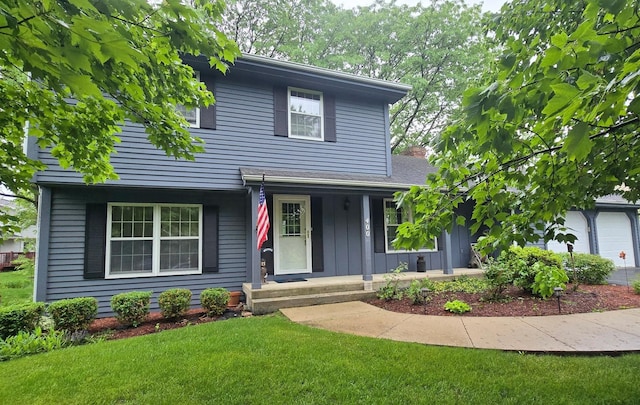 400 Seafarer Dr, Third Lake, IL 60030 - traditional-style home with covered porch, a front yard, and board and batten siding