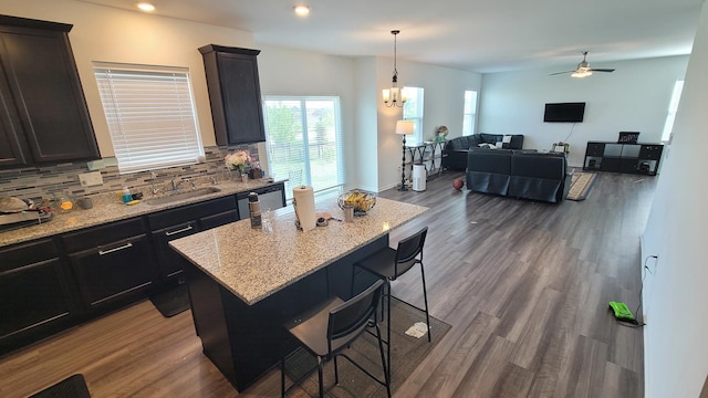 404 Radcliff Ln, South Elgin, IL 60177 - kitchen featuring tasteful backsplash, a breakfast bar, light stone countertops, dark wood finished floors, and ceiling fan