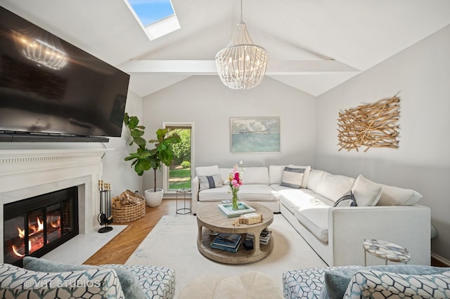 503 Oakdale Ave, Glencoe, IL 60022 - living area featuring a chandelier, wood finished floors, a skylight, a fireplace, and lofted ceiling
