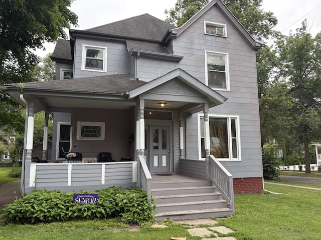 501 E Grove St, Bloomington, IL 61701 - view of front of home featuring a shingled roof and a front lawn