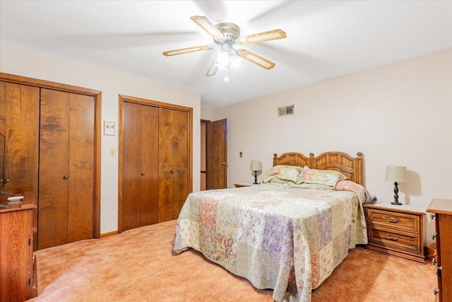 419 Circle Dr, Odell, IL 60460 - bedroom with light carpet, two closets, and ceiling fan