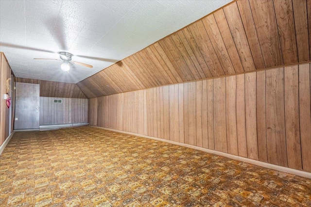 419 Circle Dr, Odell, IL 60460 - bonus room featuring wooden walls, a ceiling fan, and vaulted ceiling