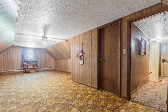 419 Circle Dr, Odell, IL 60460 - bonus room featuring a baseboard radiator, wood walls, a ceiling fan, and vaulted ceiling