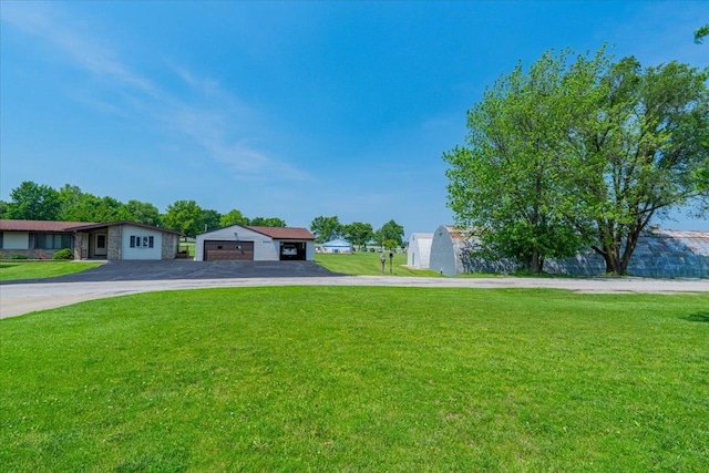 419 Circle Dr, Odell, IL 60460 - view of front facade with asphalt driveway, stone siding, a front lawn, and a garage