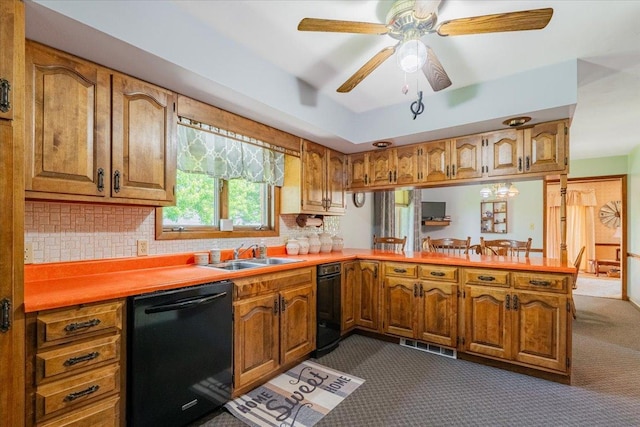 419 Circle Dr, Odell, IL 60460 - kitchen with black dishwasher, dark carpet, a peninsula, light countertops, and brown cabinetry