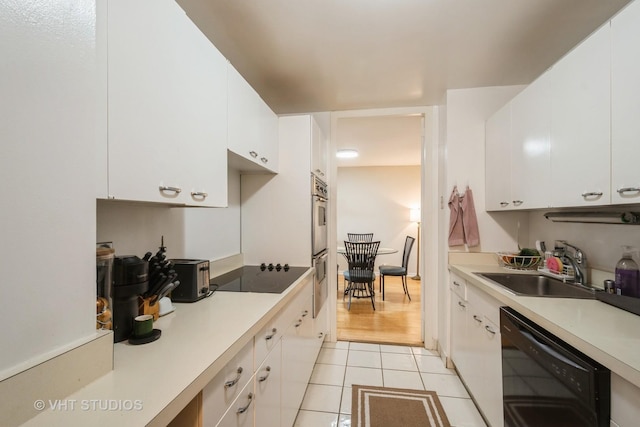 2626 N Lakeview Ave Unit 801, Chicago, IL 60614 - kitchen with black appliances, light tile patterned floors, white cabinets, and light countertops