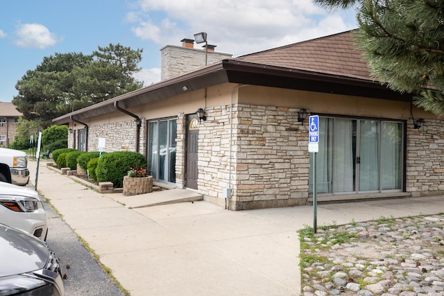 808 E Old Willow Rd Unit 208, Prospect Heights, IL 60070 - view of property exterior with stone siding and a chimney