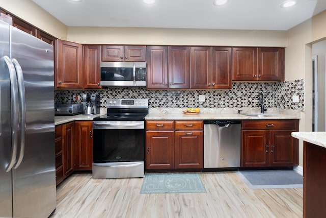 808 E Old Willow Rd Unit 208, Prospect Heights, IL 60070 - kitchen featuring appliances with stainless steel finishes, a sink, recessed lighting, light wood-style floors, and backsplash