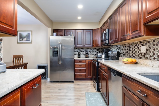 808 E Old Willow Rd Unit 208, Prospect Heights, IL 60070 - kitchen featuring stainless steel appliances, light wood-type flooring, decorative backsplash, light stone counters, and recessed lighting
