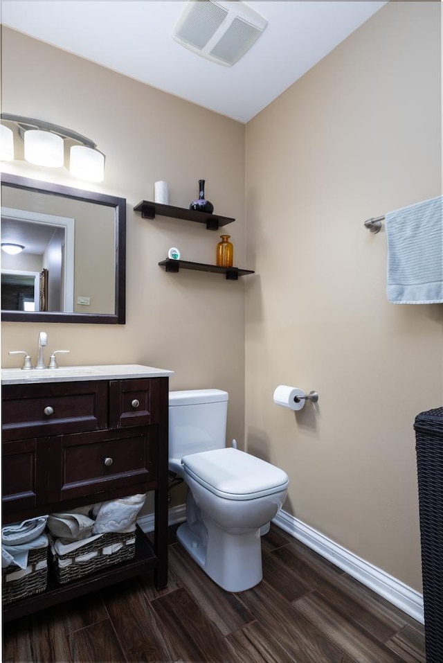 808 E Old Willow Rd Unit 208, Prospect Heights, IL 60070 - half bathroom featuring wood finished floors, toilet, vanity, and baseboards