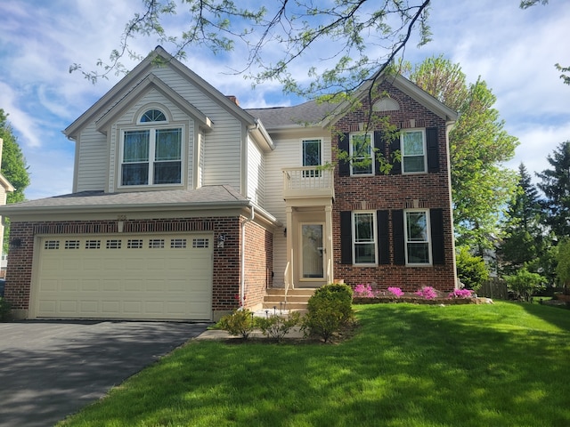 355 Wentworth Ln, Bartlett, IL 60103 - view of front of home featuring an attached garage, driveway, a front yard, brick siding, and a balcony
