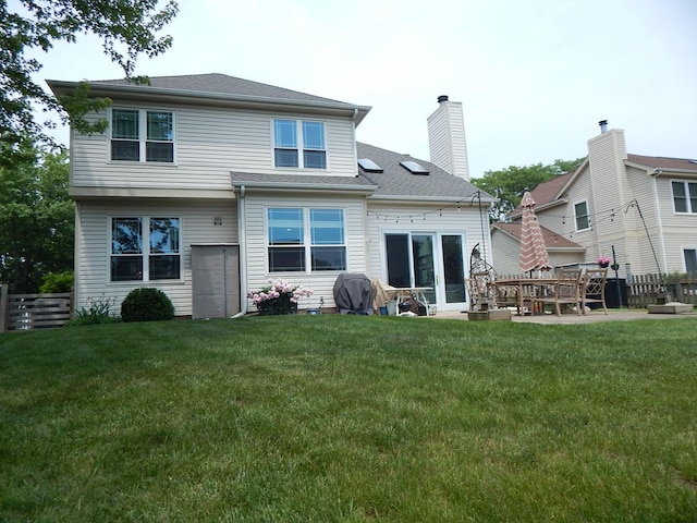 355 Wentworth Ln, Bartlett, IL 60103 - rear view of house with a lawn and a chimney