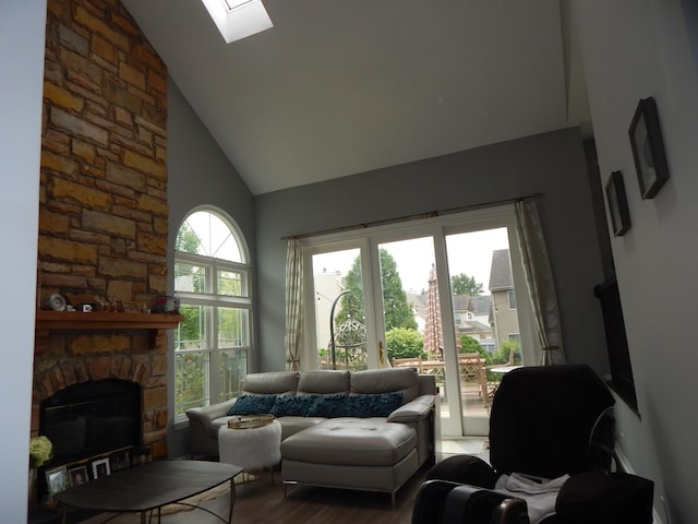 355 Wentworth Ln, Bartlett, IL 60103 - living room with high vaulted ceiling, a skylight, a stone fireplace, and wood finished floors