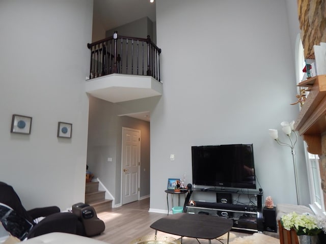 355 Wentworth Ln, Bartlett, IL 60103 - living room with a towering ceiling, stairs, wood finished floors, healthy amount of natural light, and baseboards