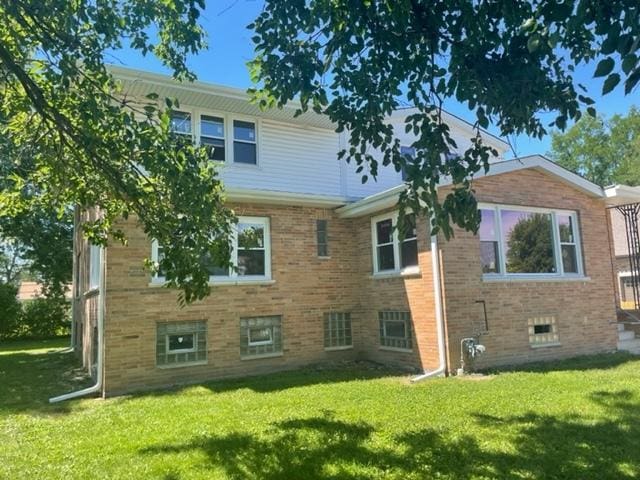 8110 Lockwood Ave, Burbank, IL 60459 - back of property with a lawn and brick siding
