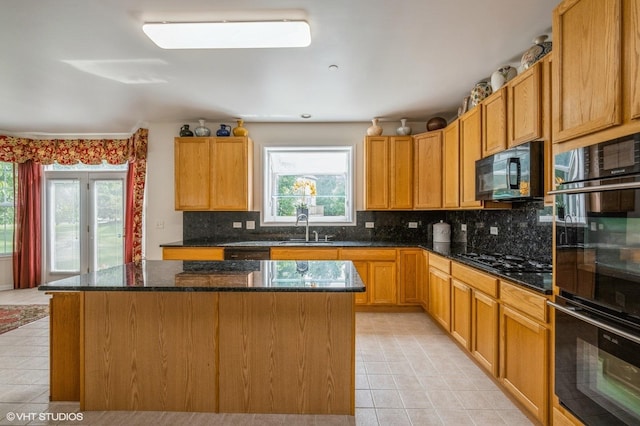 5436 Swan Cir, Hoffman Estates, IL 60192 - kitchen featuring black appliances, light tile patterned floors, a center island, and decorative backsplash