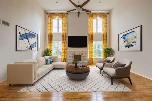 5436 Swan Cir, Hoffman Estates, IL 60192 - living area with a high ceiling, light wood finished floors, ceiling fan, plenty of natural light, and a fireplace