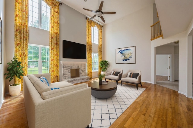 5436 Swan Cir, Hoffman Estates, IL 60192 - living area with high vaulted ceiling, a ceiling fan, wood finished floors, and a brick fireplace