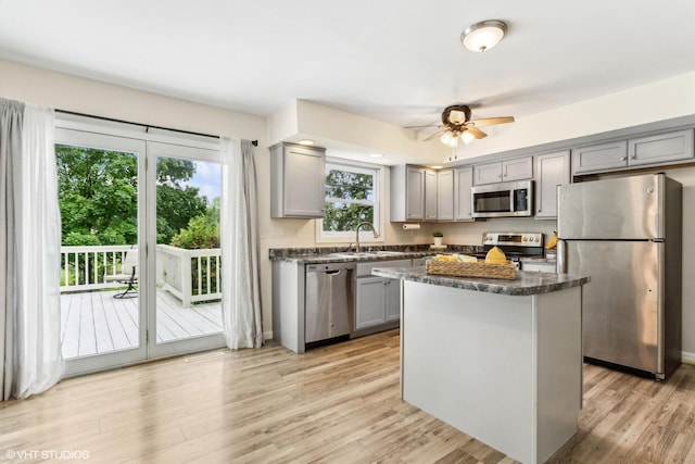 11 Willow Ct, Spring Valley, IL 61362 - kitchen featuring stainless steel appliances, gray cabinetry, a kitchen island, light wood finished floors, and a ceiling fan