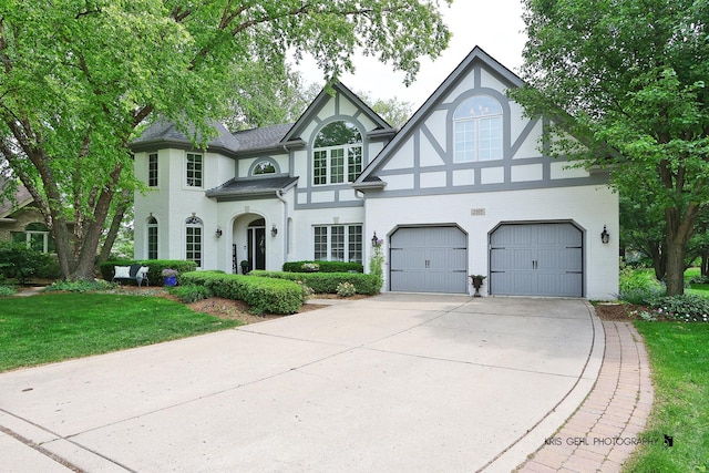 2515 Thurston Ct, Aurora, IL 60502 - view of front of house with concrete driveway, a garage, a front lawn, stucco siding, and a shingled roof