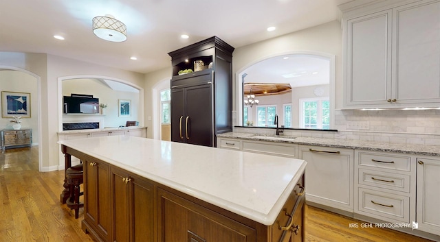 2515 Thurston Ct, Aurora, IL 60502 - kitchen featuring paneled refrigerator, a center island, light wood-style flooring, recessed lighting, and tasteful backsplash