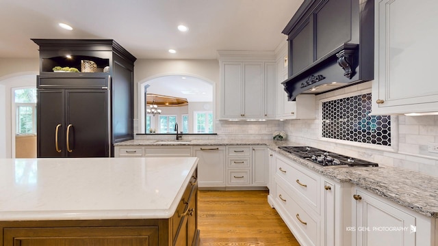 2515 Thurston Ct, Aurora, IL 60502 - kitchen with stainless steel gas cooktop, arched walkways, custom range hood, decorative backsplash, and recessed lighting