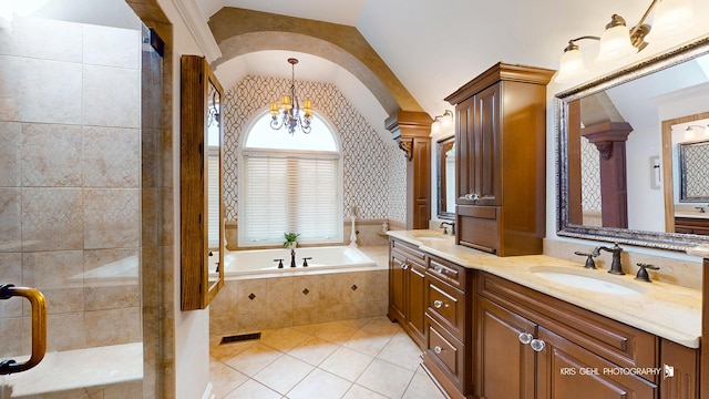 2515 Thurston Ct, Aurora, IL 60502 - bathroom with lofted ceiling, double vanity, a bath, a chandelier, and tile patterned floors