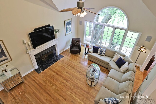 2515 Thurston Ct, Aurora, IL 60502 - living room featuring a premium fireplace, a ceiling fan, wood finished floors, and high vaulted ceiling
