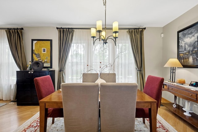 5055 N California Ave Unit 1S, Chicago, IL 60625 - dining room featuring a chandelier and wood finished floors