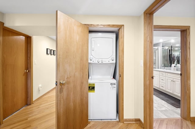5055 N California Ave Unit 1S, Chicago, IL 60625 - laundry room featuring stacked washer / dryer and light wood finished floors