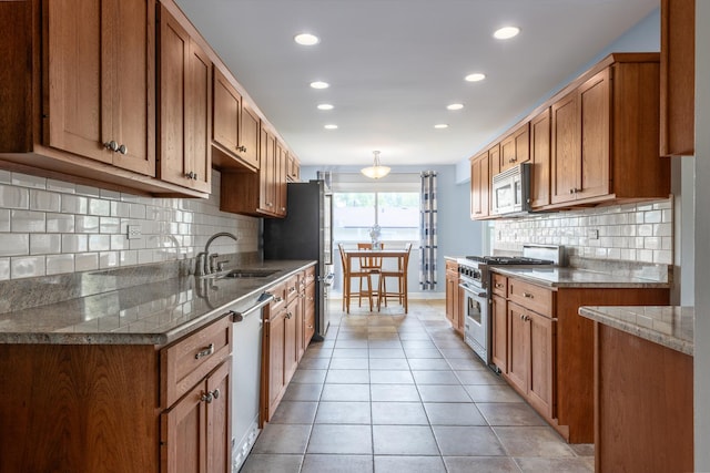 31 W Devon Ave, Glendale Heights, IL 60139 - kitchen featuring stainless steel appliances, a sink, recessed lighting, light tile patterned flooring, and brown cabinets