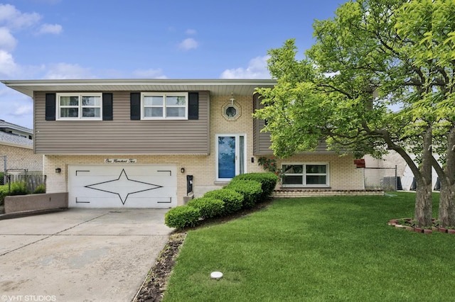 102 S Grant Dr, Addison, IL 60101 - raised ranch with an attached garage, brick siding, a front lawn, and concrete driveway