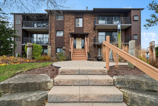 47 Pier Dr Unit 102, Westmont, IL 60559 - multi unit property with a balcony, brick siding, and board and batten siding