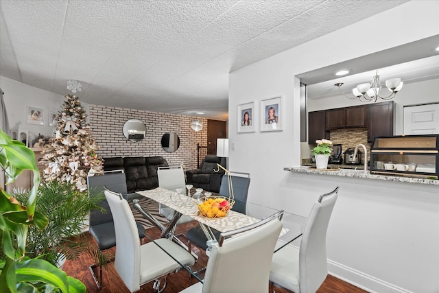 47 Pier Dr Unit 102, Westmont, IL 60559 - dining room featuring a chandelier, wood finished floors, a fireplace, recessed lighting, and a textured ceiling