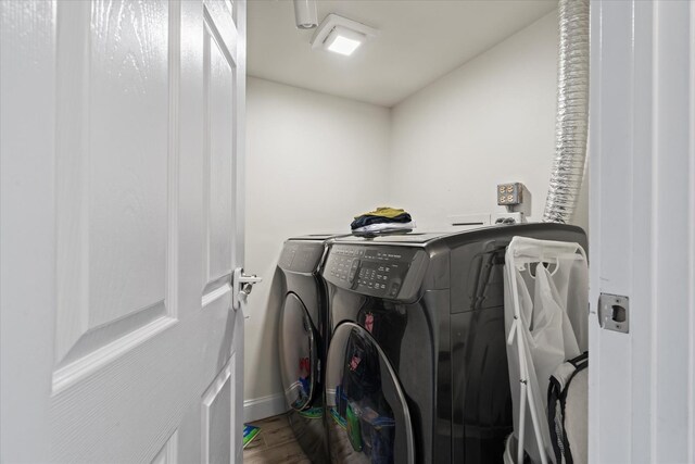 47 Pier Dr Unit 102, Westmont, IL 60559 - laundry room with independent washer and dryer, dark wood-style flooring, and baseboards