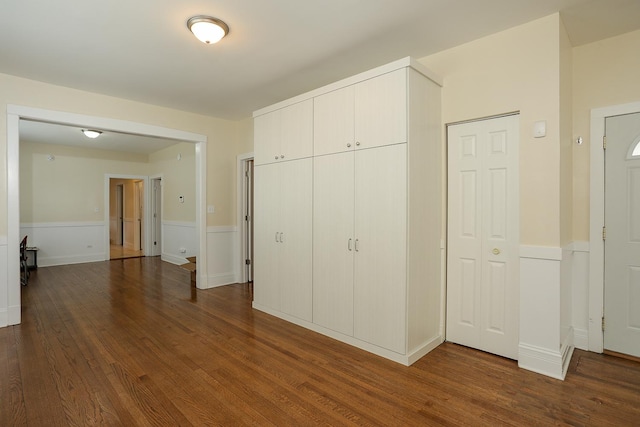 401 N Humphrey Ave, Oak Park, IL 60302 - unfurnished bedroom with dark wood-style floors, wainscoting, and a closet