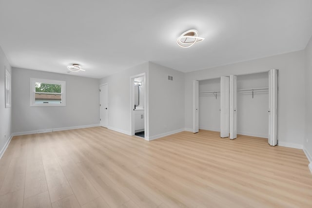 18624 W Pamela Pl, Gurnee, IL 60031 - unfurnished bedroom with two closets, light wood-style flooring, and ensuite bath