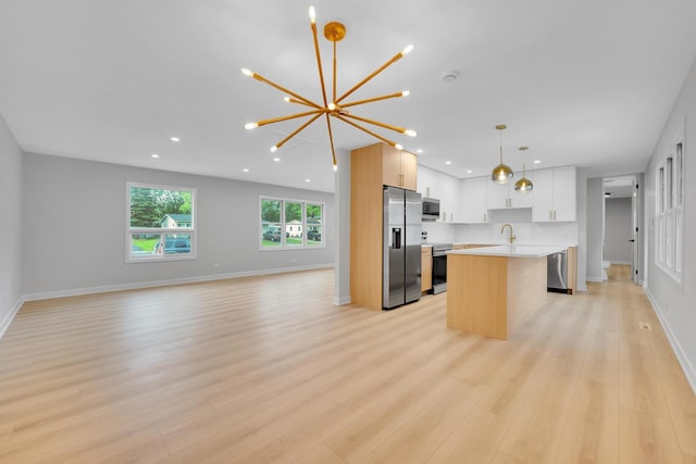 18624 W Pamela Pl, Gurnee, IL 60031 - kitchen featuring appliances with stainless steel finishes, open floor plan, light countertops, a chandelier, and light wood-type flooring