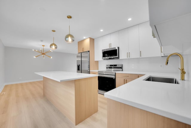 18624 W Pamela Pl, Gurnee, IL 60031 - kitchen with stainless steel appliances, light wood-style floors, hanging light fixtures, a center island, and light countertops