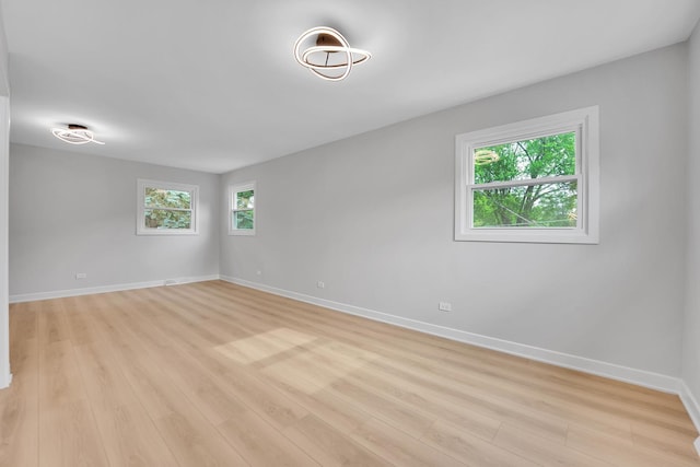 18624 W Pamela Pl, Gurnee, IL 60031 - empty room with healthy amount of natural light and light wood-style floors