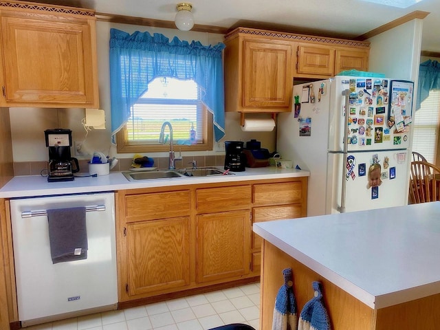 101 Crescent Dr, Watseka, IL 60970 - kitchen with stainless steel dishwasher, a sink, freestanding refrigerator, light countertops, and brown cabinetry