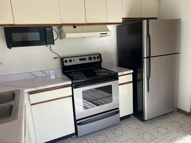 1744 Eastwood Ct Unit 3, Schaumburg, IL 60195 - kitchen with under cabinet range hood, stainless steel appliances, light flooring, and white cabinetry